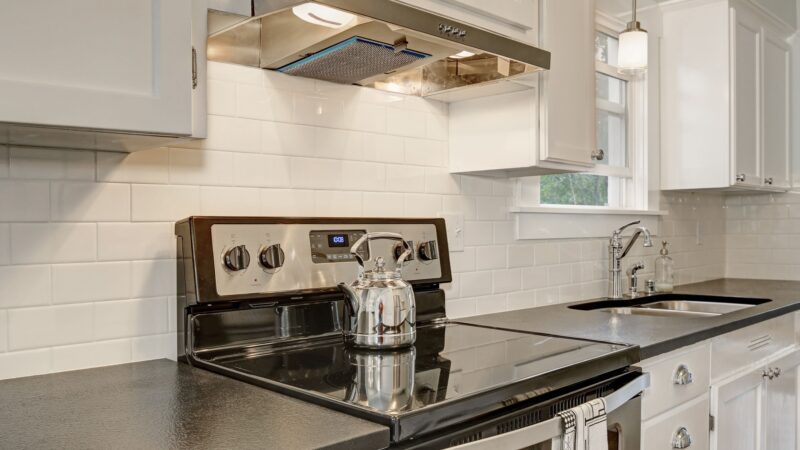 White kichen with new appliances exemplifying ways to save energy on a home