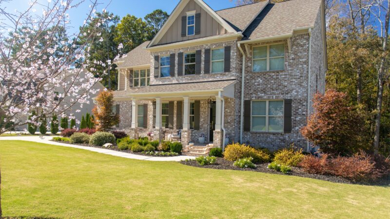 A tan brick home in a sought after neighborhood.