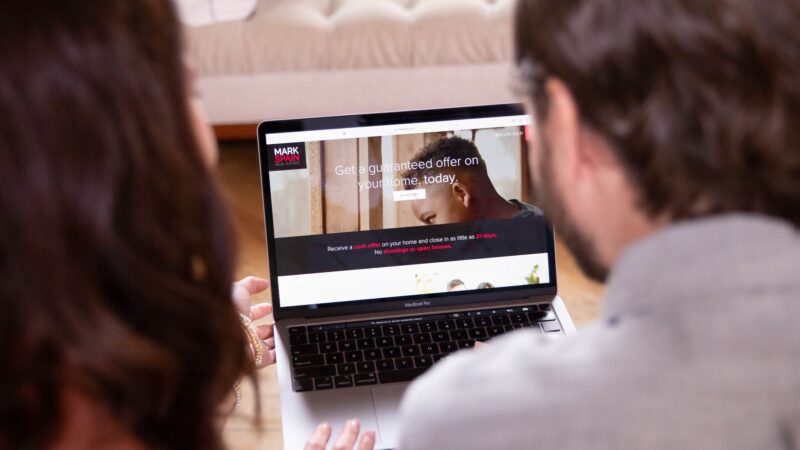 Couple learning about their selling options like the Mark Spain Real Estate Guaranteed Offer