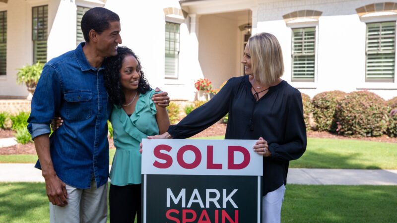 agent and clients standing in front of sold house - Sarah’s Seamless Sale