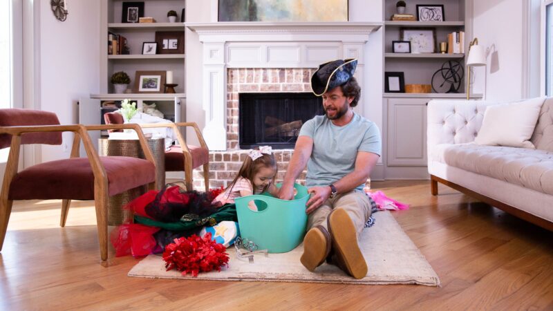 Father after completing the transaction as a first-time home buyer with his daughter in their new living room. 