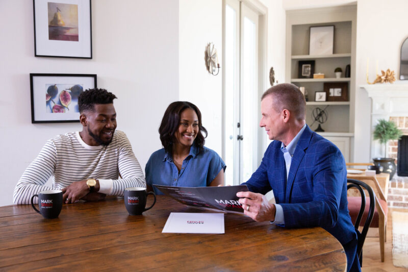 mark sitting at table with couple - sell your home this fall